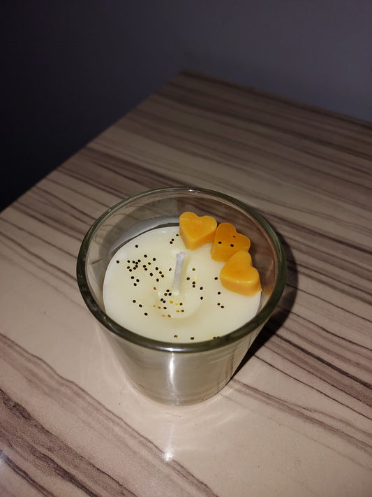 Two-tone swirl soy candle in white and yellow, artisan hand-poured design